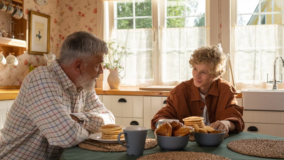 A serene morning breakfast setting with grandfather and grandson sharing pancakes and togetherness.